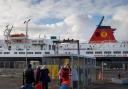 Passengers wait to board the CalMac ferry, Caledonian Isles at Ardrossan bound for Brodick on Arran.