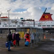 Passengers wait to board the CalMac ferry, Caledonian Isles at  Ardrossan bound for Brodick on Arran...Photograph by Colin Mearns.29 November 2022.