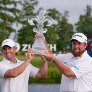 Rory McIlroy and Shane Lowry hold up their trophy after winning the PGA Zurich Classic golf tournament (Gerald Herbert/AP)