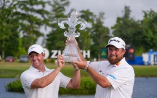 Rory McIlroy and Shane Lowry hold up their trophy after winning the PGA Zurich Classic golf tournament (Gerald Herbert/AP)