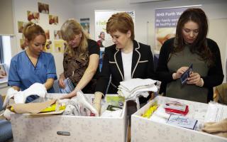Nicola Sturgeon with the first baby boxes to be delivered