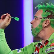 Peter Wright came dressed as the Grinch as he began the defence of his World Championship title