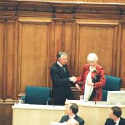 Winnie Ewing hands over the chair to Sir David Steele at the first session of the new Scottish Parliament