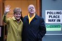 SNP leader Nicola Sturgeon with husband Peter Murrell as they cast their votes in the 2019 General Election at Broomhouse Park Community Hall in Glasgow. PA Photo. Picture date: Thursday December 12, 2019. See PA story POLITICS Election. Photo credit