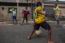 Boys play football  in the streets of the Garden Gloria neighborhood in the city of Praia Grande