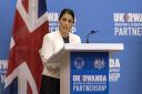 Britain's Home Secretary Priti Patel speaks to the media after the Conservative government  struck a deal to send some asylum-seekers thousands of miles away to Rwanda. (AP Photo/Muhizi Olivier).