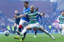 Celtic winger Daizen Maeda, right, diverts a clearance by Rangers captain James Tavernier, left, into the opposition net at Ibrox on Sunday