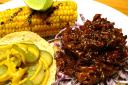 Vegan BBQ pulled jackfruit with coleslaw and a chipotle butter and lime corn on the cob