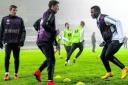 Stefan Scepovic watches as Aleksandar Tonev, centre, and Wakaso Mubarak are put through their paces in Bucharest. Picture: Sammy Turner/SNS