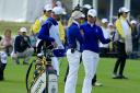 Suzann Pettersen and her captain Carin Koch discuss the length of putt that she did not concede to Alison Lee on the 17th green. Picture: David Cannon/Getty Images