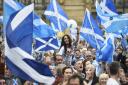 Campaigners wave Scottish Saltires at a 'Yes' campaign rally in Glasgow, Scotland September 17, 2014.