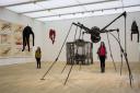 LONDON, ENGLAND - JUNE 14: Tate employees pose with 'Spider' by Louise Bourgeois (R) and 'Single II' by Louise Bourgeois (hanging) at the Tate Modern's new Switch House on June 14, 2016 in London, England. The Tate Modern art gallery u