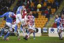 St Johnstone's Graham Cummins heads home his side's opening goal. Picture: SNS