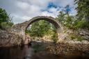 The bridge was built to solve the problem of funerals being delayed when mourners could not cross the River Dulnain to attend.