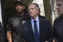 Brazil's Olympic Committee chief Carlos Nuzman (C) is escorted from his home by federal police in Rio de Janeiro on October 5, 2017. Brazilian police on October 5 arrested the chairman of the Brazilian Olympic Committee as part of a probe into alleged