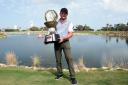 DOHA, QATAR - FEBRUARY 25: Eddie Pepperell of England poses with the trophy following his victory during the final round of the Commercial Bank Qatar Masters at Doha Golf Club on February 25, 2018 in Doha, Qatar. (Photo by Tom Dulat/Getty Images).