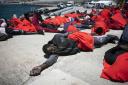 Migrants rest at the port of Tarifa, southern Spain, after being rescued by Spain's Maritime Rescue Service in the Strait of Gibraltar. (AP Photo/Marcos Moreno).