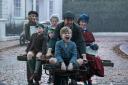 Emily Blunt, in blue hat, shows the way to family fun in Mary Poppins