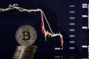 PARIS, ILE DE FRANCE - NOVEMBER 20:  In this photo illustration, a visual representation of the digital Cryptocurrency, Bitcoin is displayed in front of the Bitcoin course's graph of Bitfinex cryptocurrency exchange website on November 20, 2018 in Par