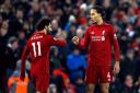 Liverpool's Mohamed Salah (left) celebrates scoring his side's third goal of the game with team-mate Virgil van Dijk during the Premier League match at Anfield, Liverpool. PRESS ASSOCIATION Photo. Picture date: Saturday January 19, 2019. See PA s