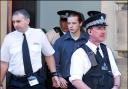Luke Mitchell is led away from court after being found guilty of murder in January 2005