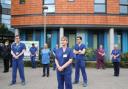 NHS staff take part in the silent tribute to fallen colleagues
