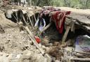 An Afghan villager collects his belongings from under the rubble of his home that was destroyed in an earthquake in the Spera District of the southwestern part of Khost Province, Afghanistan, Wednesday, June 22, 2022. A powerful earthquake struck a
