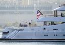 FILE - People look on from the super yacht Amadea as it arrives to the San Diego Bay Monday, June 27, 2022, seen from Coronado, Calif. The $325 million superyacht seized by the United States from a sanctioned Russian oligarch arrived in San Diego Bay on