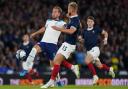 Scotland defender Ryan Porteous, right, tries to tackle England captain Harry Kane at Hampden tonight
