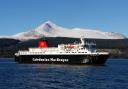The MV Caledonian Isles in front of a snow-covered Goat Fell, the highest mountain on the Isle of Arran.