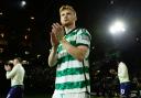 Liam Scales applauds the Celtic fans after a match