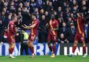 Motherwell players celebrate after Dan Casey's winner at Ibrox.