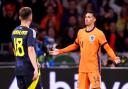Tijjani Reijnders, right, celebrates his goal for the Netherlands in the Johan Cruyff Arena in Amsterdam tonight as Scotland striker Lawrence Shankland looks on in depair