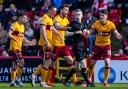 Referee Craig Napier shows Motherwell's Jack Vale a red card
