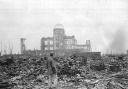 An Allied correspondent stands in a sea of rubble in Hiroshima a month after the bomb was dropped in 1945. How big is the risk of such scenes being repeated?