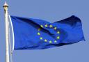 The blue and yellow flag of the EU