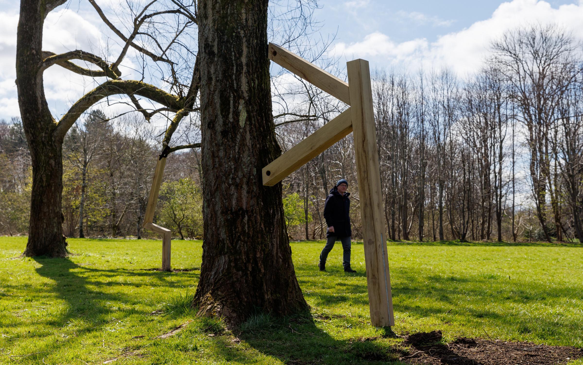 National Covid Memorial at Riverside Grove in Pollok Country Park. Pictured is Billy Boyce looking at the I Remember tree supports created by artist Alec Finlay that have started to be erected. Photograph by Colin Mearns.