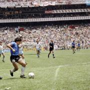 Argentinian forward Diego Armando Maradona (3rd L) runs past English defender Terry Butcher (L) on his way to dribbling goalkeeper Peter Shilton (R) and scoring his second goal, or goal of the century, during the World Cup quarterfinal soccer match