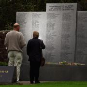 Relatives pause at the Lockerbie memorial