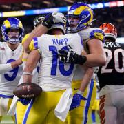 Los Angeles Rams wide receiver Cooper Kupp (10) is congratulated by teammates after scoring a touchdown against the Cincinnati Bengals during the second half of the NFL Super Bowl