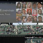 Photos of the victims of the shooting at Robb Elementary School in Uvalde, Texas, are shown on a video display at T-Mobile Park Friday, May 27, 2022, during a moment of silence before a baseball game between the Seattle Mariners and the Houston Astros in