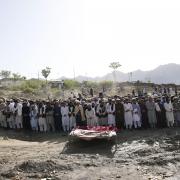 Afghans pray for relatives killed in an earthquake to a burial site l in Gayan village, in Paktika province, Afghanistan, Thursday, June 23, 2022. A powerful earthquake struck a rugged, mountainous region of eastern Afghanistan early Wednesday,