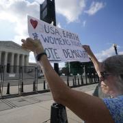 An abortion-rights protester demonstrates in front of the Supreme Court in Washington, (AP Photo/Steve Helber)