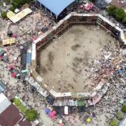 In this image taken from video, spectators are sent plunging to the ground as part of a wooden stand collapses during a bullfight, Sunday, June 26, 2022, at a stadium in the city of El Espinal in Tolima state, central Colombia. (AP Video)