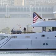 FILE - People look on from the super yacht Amadea as it arrives to the San Diego Bay Monday, June 27, 2022, seen from Coronado, Calif. The $325 million superyacht seized by the United States from a sanctioned Russian oligarch arrived in San Diego Bay on