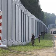 Polish border guards patrol the area of a newly built metal wall on the border between Poland and Belarus, near Kuznice, Poland, Thursday, June 30, 2022. A year after migrants started crossing into the European Union from Belarus to Poland, Polish Prime