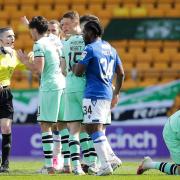 Referee Craig Napier is surrounded by Hibs players after controversially sending off Jimmy Jeggo.
