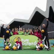 Sam Kerr and Kenny Miller attend an event to promote the re-opening of McDonald's Fun Football centres