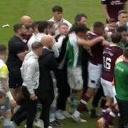The Hearts and Hibs players and staff square off at the end of Saturday's Edinburgh derby.