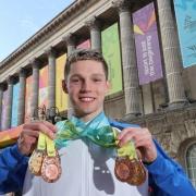 Duncan Scott shows off his medals from the Commonwealth Games. However, he will be swimming in only one individual race at the World Championships